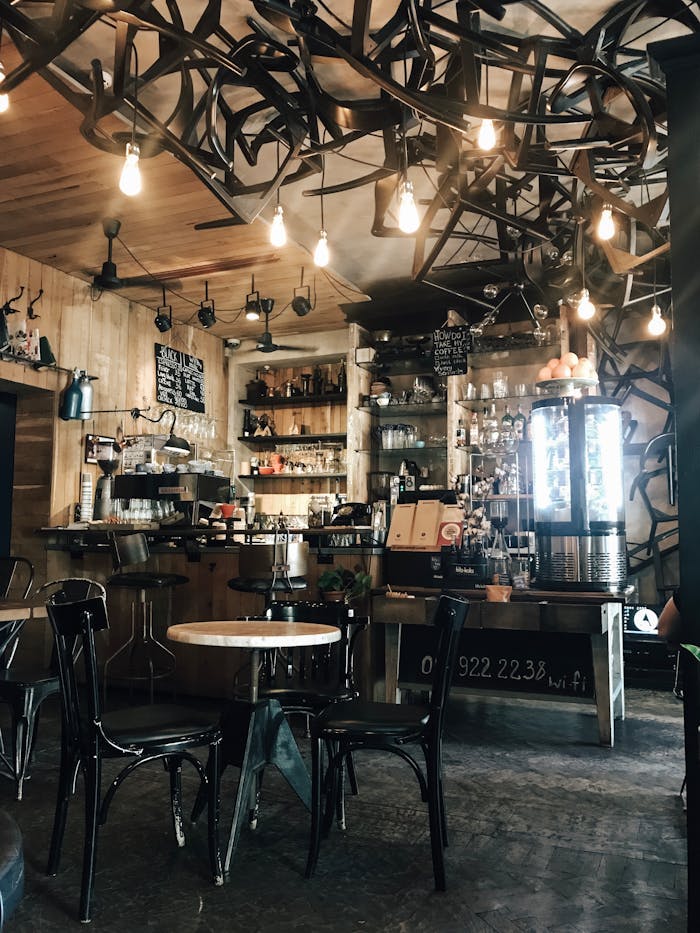 Warm and inviting modern coffee shop interior with unique lighting and wooden elements.